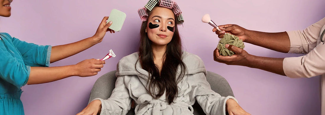 Woman in robe with hair rollers and under-eye patches, surrounded by beauty tools and hands offering skincare items