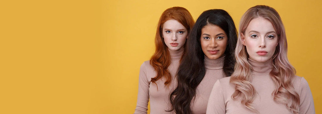 Three women with diverse hair colors and makeup styles against yellow background